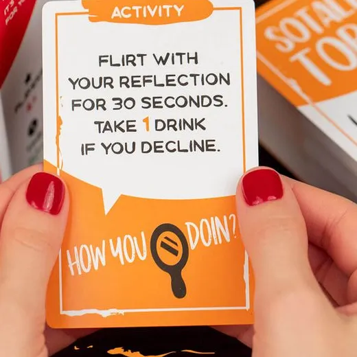 Hands holding a Close & Personal activity card