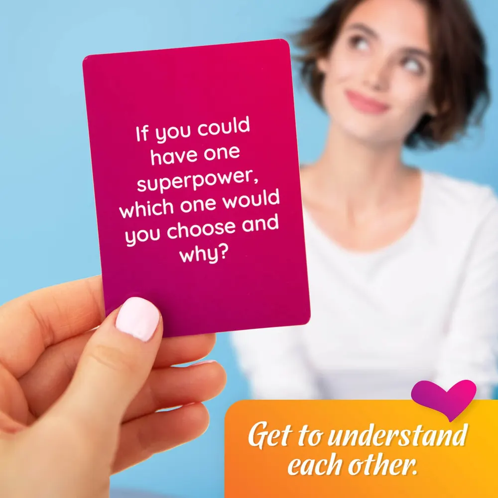 A New Couples question card held up between partners